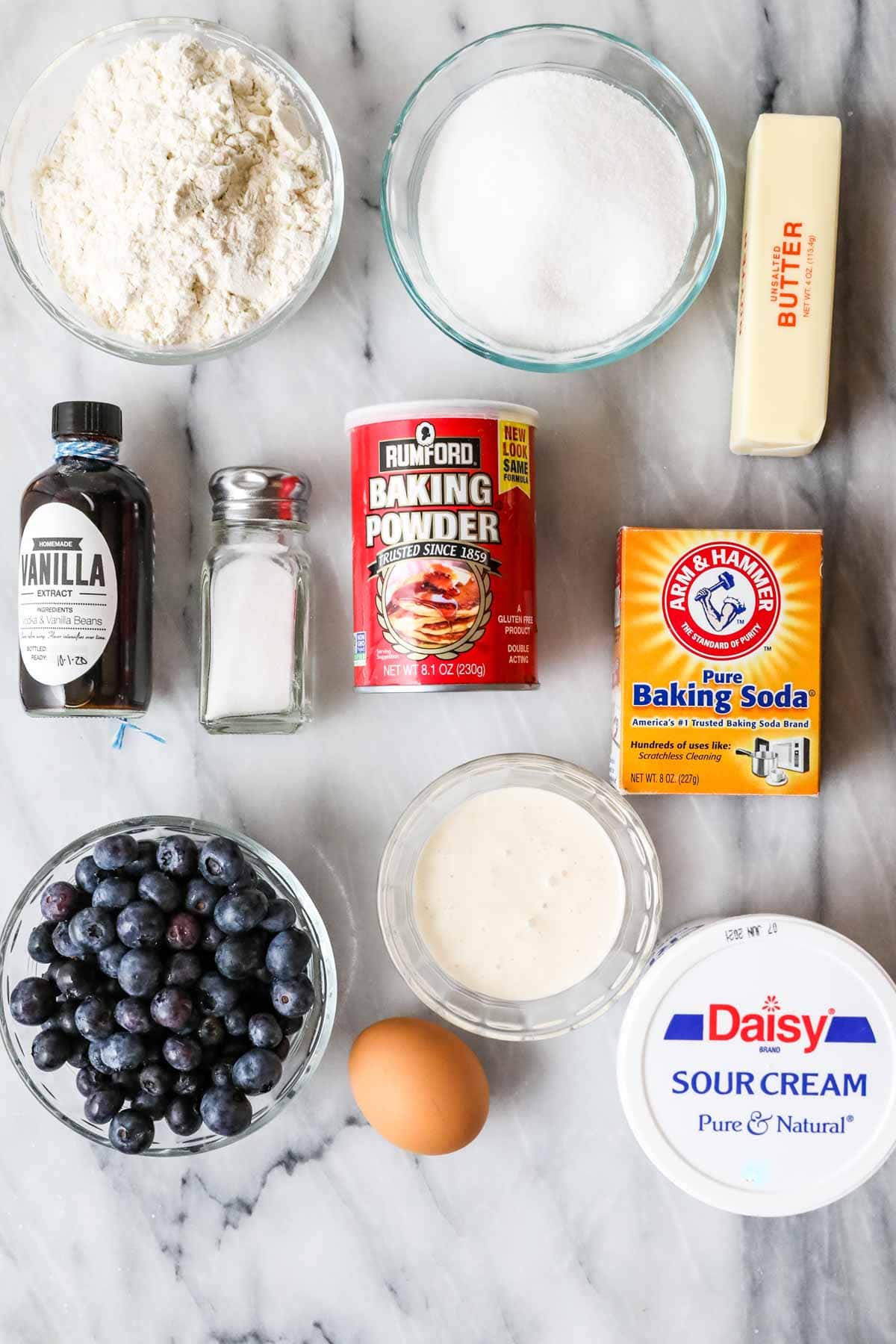 Overhead view of ingredients including blueberries, sourdough discard, sour cream, and more.