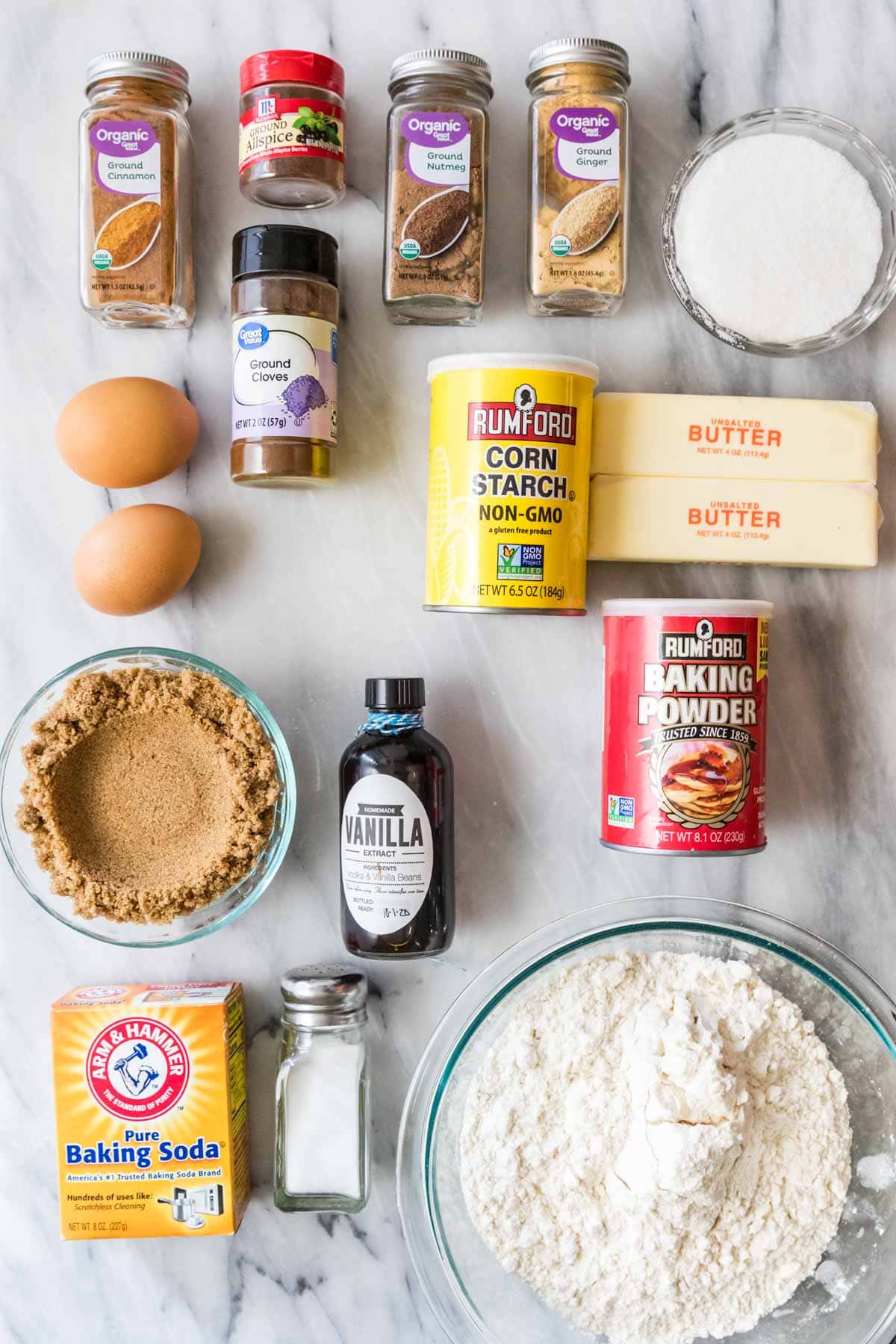 Overhead view of ingredients including spices, brown sugar, flour, and more.