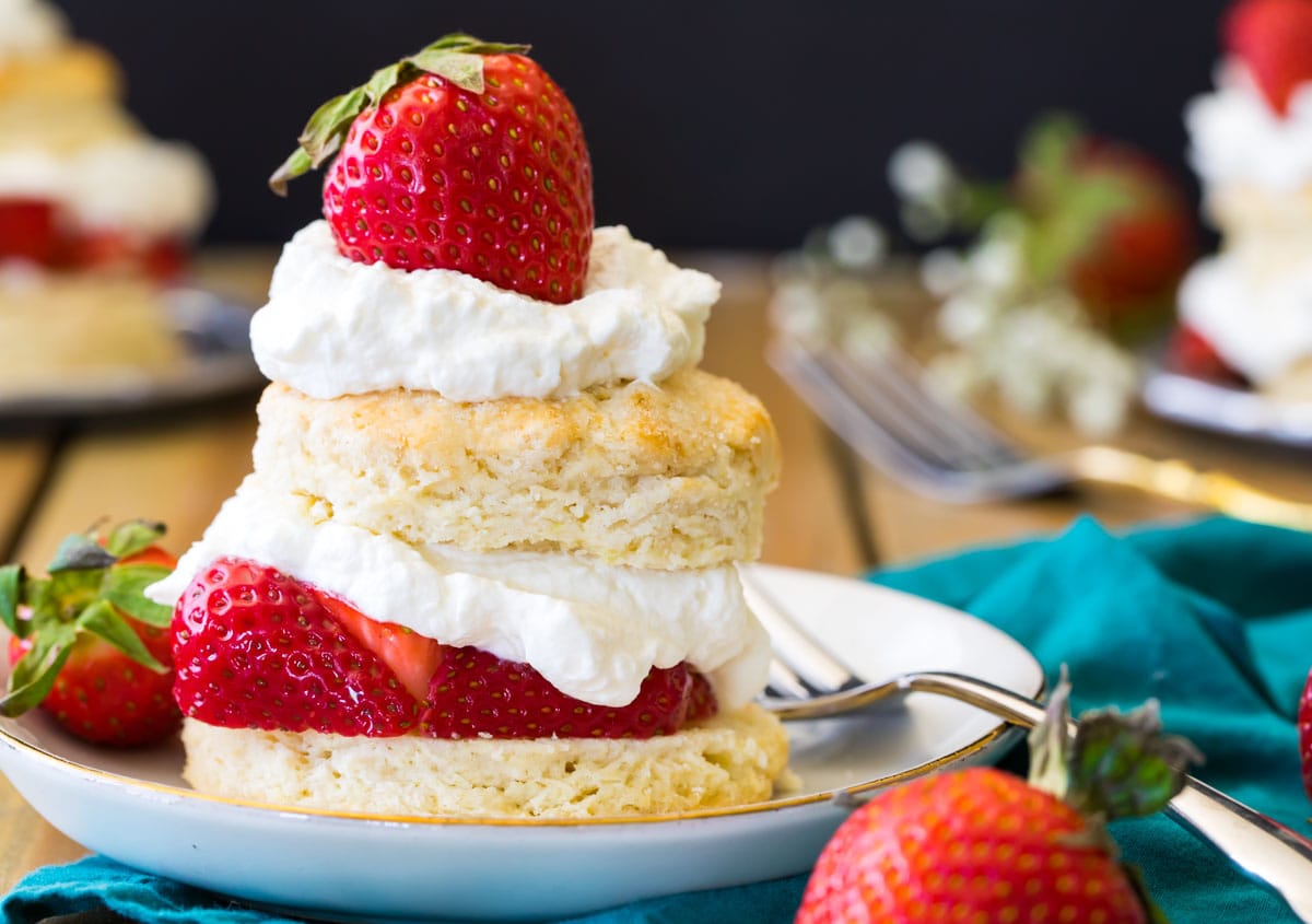 Strawberry shortcake on a white plate with a fork.